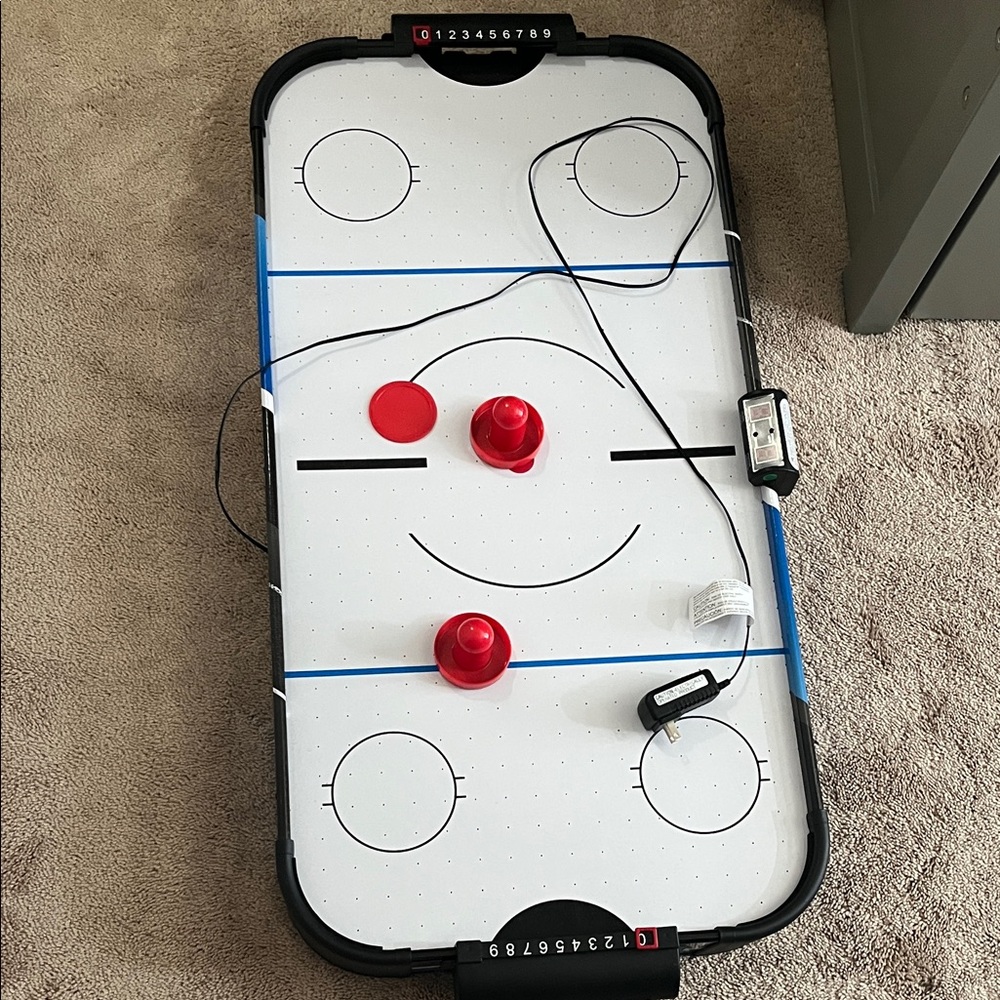 Compact Air Hockey Table with Red Accessories